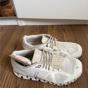 On Running Cream and White Athletic Shoes